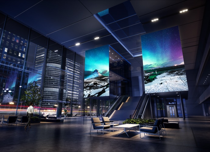 Large entrance lobby open space with 2 large LED screen walls of colorful images