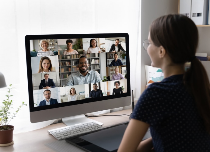 Woman working form home with teams meeting on screen