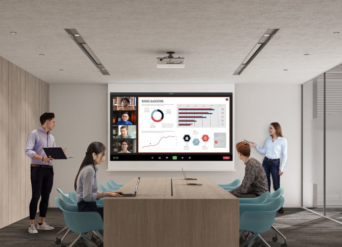 Woman standing up presenting on a large display screen