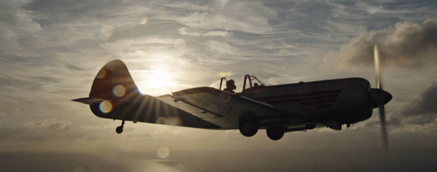 Yakovlev Yak-50 aircraft with sun behind it