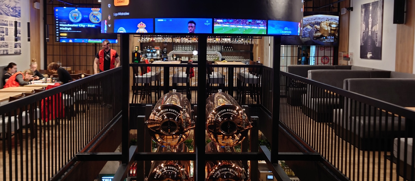 A large circular screen and multiple BRAVIA Screens displaying sports