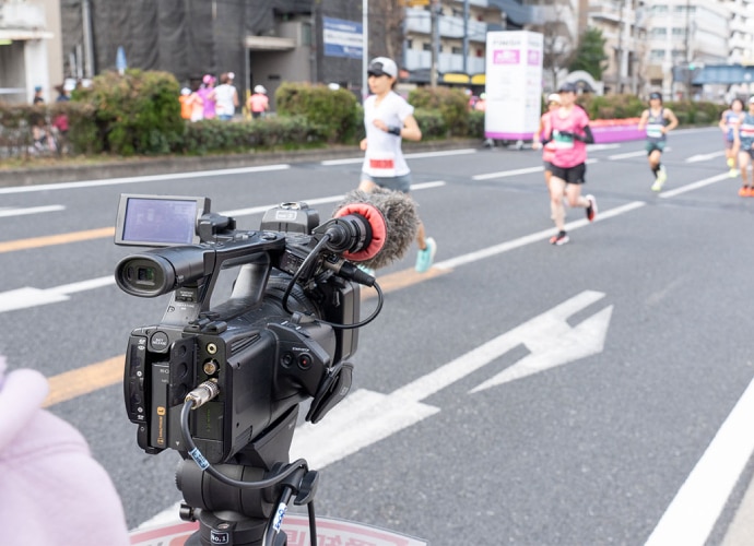 Runners being recorded by a static camera