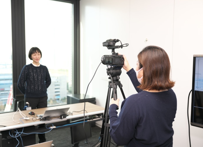 Scene of a speaker being recorded by a Sony camera in an office