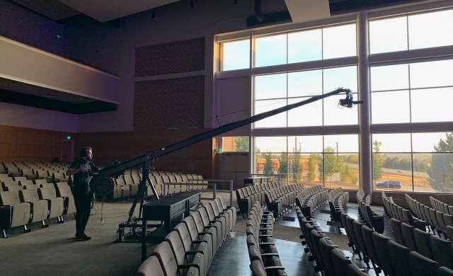 An empty auditorium with a camera on a crane.