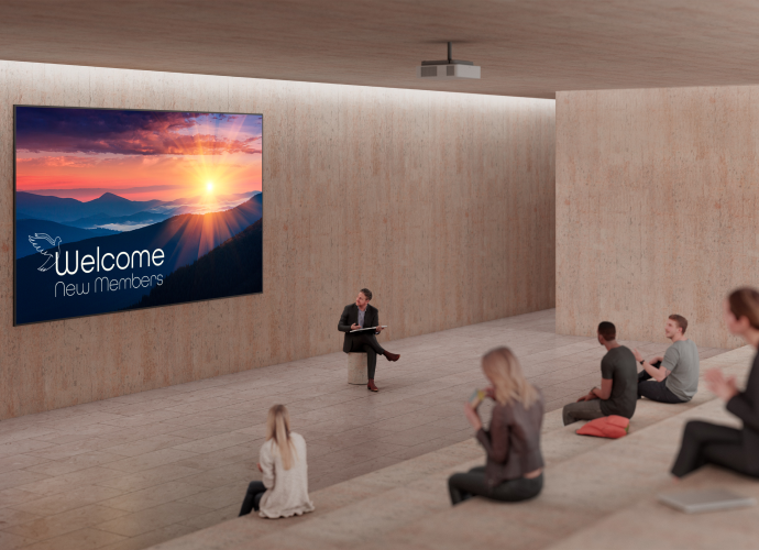 An auditorium with a ceiling-mounted laser projector.