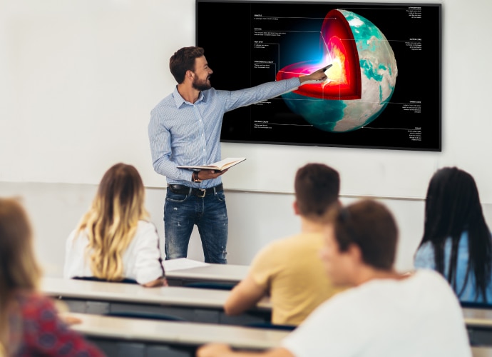 A teacher using a BRAVIA display to explain a lesson to students