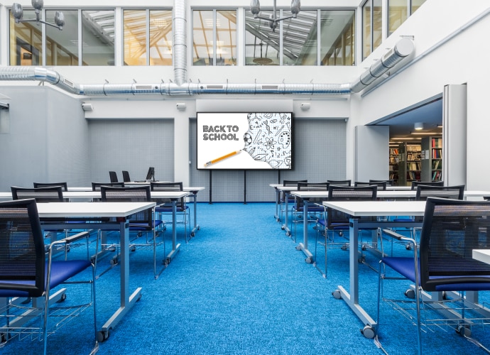 An empty school hall with a BRAVIA on the wall