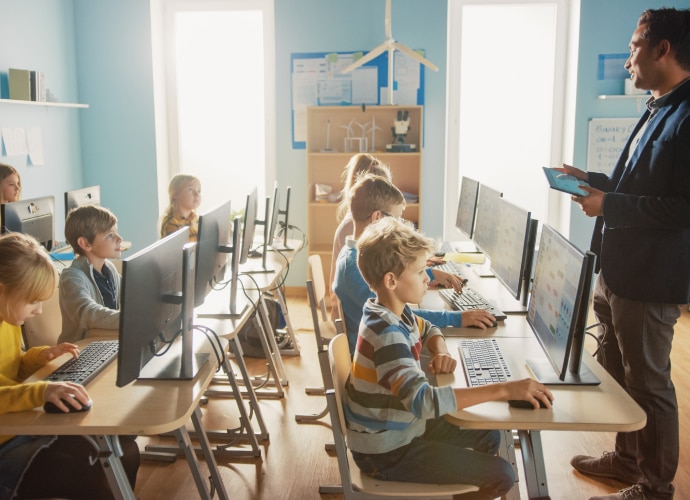 Schoolchildren studying in front of computers