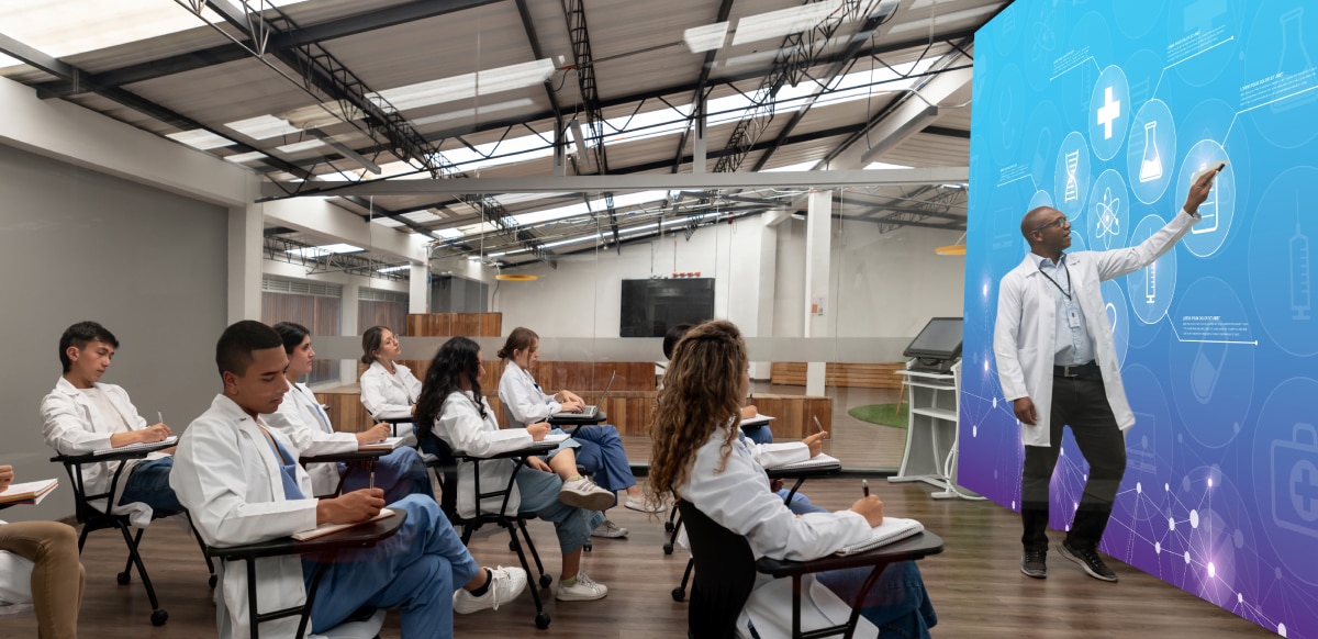 A teacher giving a lecture using a CLED wall