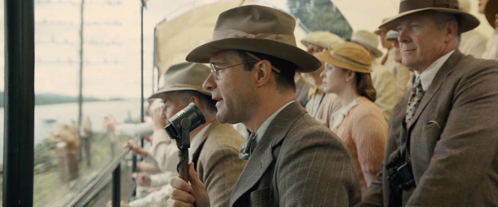 Close-up of race commentator in scene from Boys In The Boat.