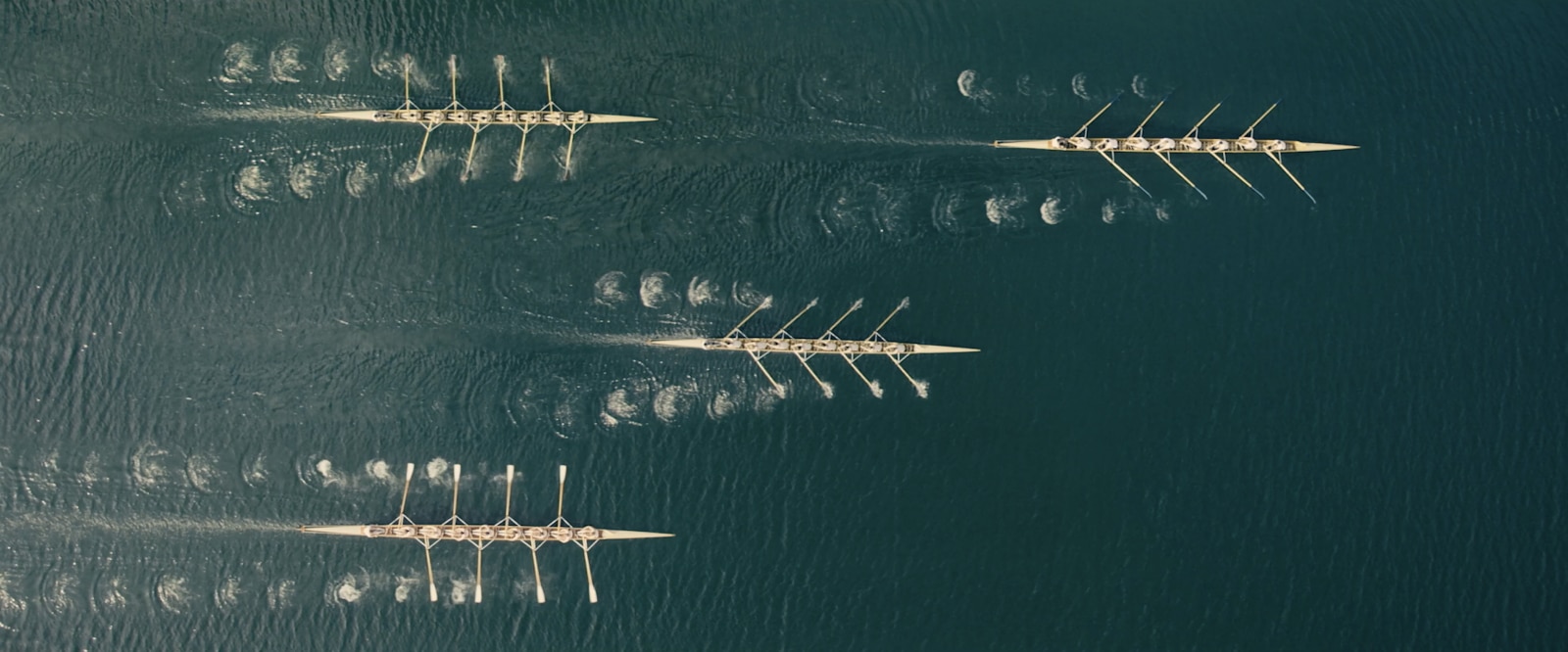 Overhead shot of three boats competing.