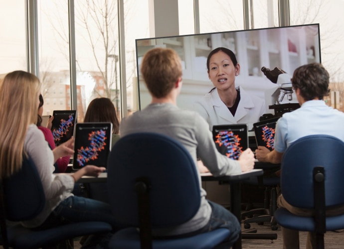 A teacher interacts with students in the classroom via a BRAVIA display