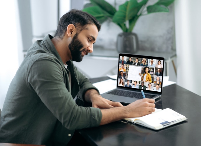 A student having an online class with other students on his laptop screen