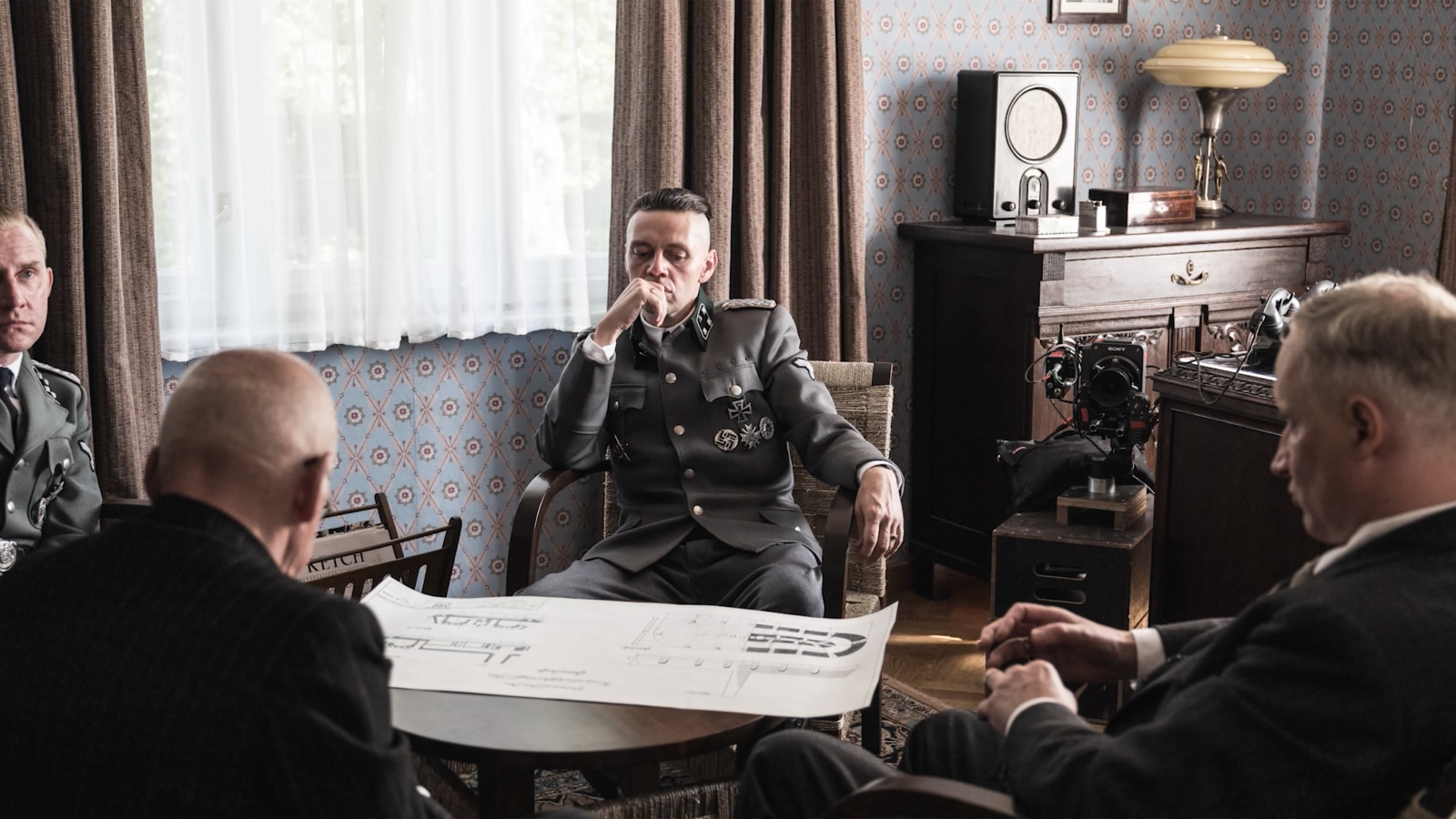 The Nazi concentration commandant in discussion over plans for the camp.