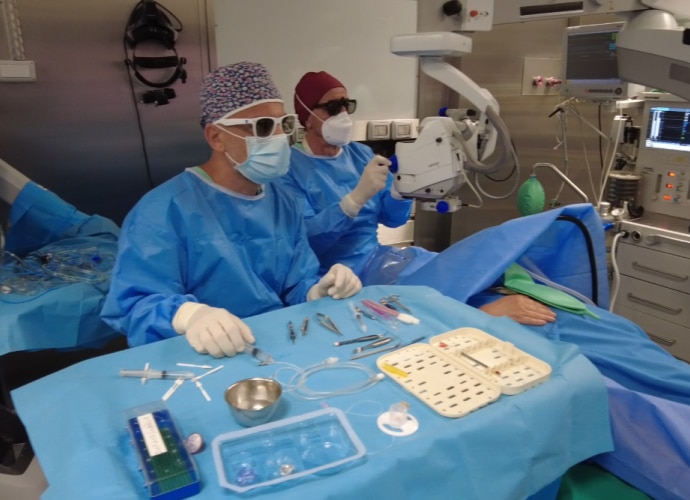 Two surgeons in 3d glasses performing eye operation using sony 3d surgical display