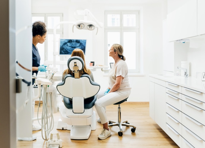 A dentist showing the x-ray image of teeth to the patient