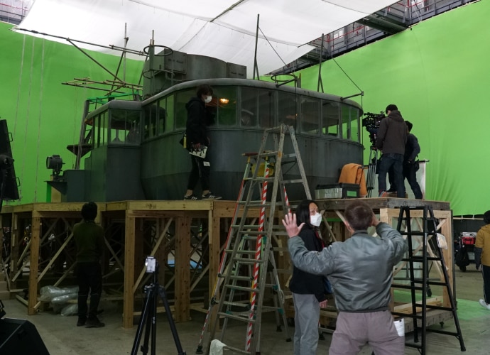 Crew Module Greenscreen A replica of a fishing boat in front of a greenscreen. It is surrounded ...